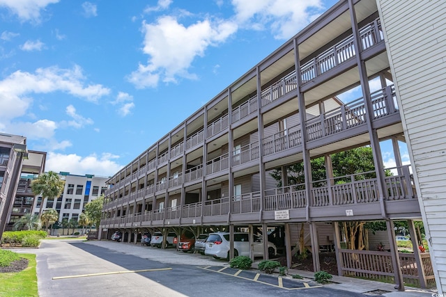 207 N Ocean Blvd Unit 241, North Myrtle Beach, SC 29582 - view of apartment building / complex featuring covered parking