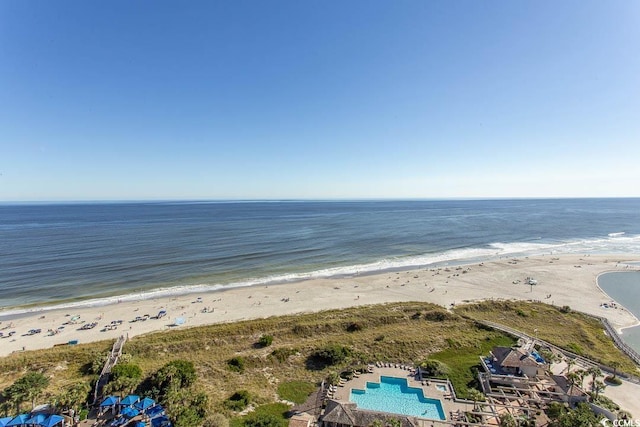 bird's eye view featuring a water view and a beach view