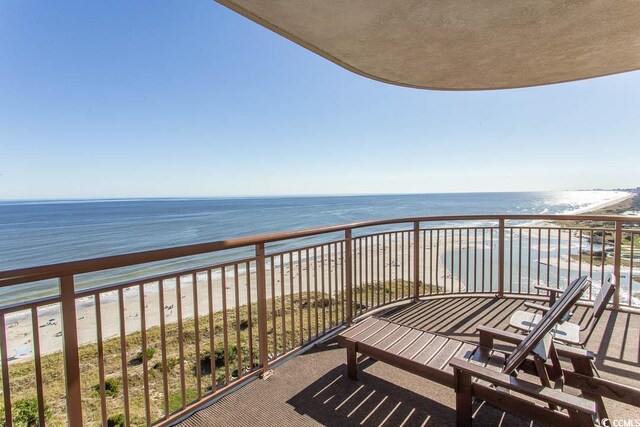 balcony with a water view and a beach view