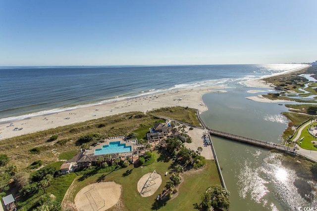 drone / aerial view featuring a water view and a view of the beach