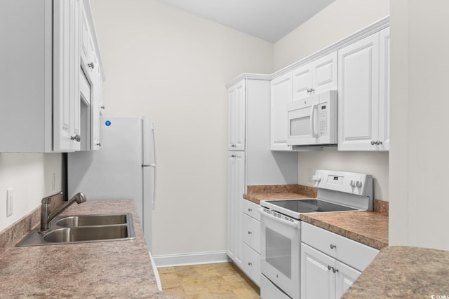 kitchen with white cabinetry, white appliances, and sink