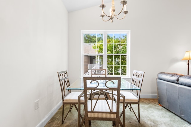 dining space with a chandelier, lofted ceiling, and carpet