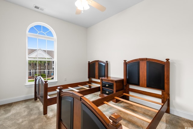 carpeted office space with ceiling fan