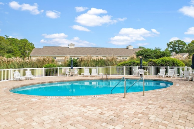 view of swimming pool with a patio area