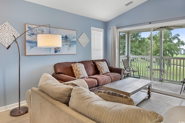 living room with vaulted ceiling and hardwood / wood-style flooring