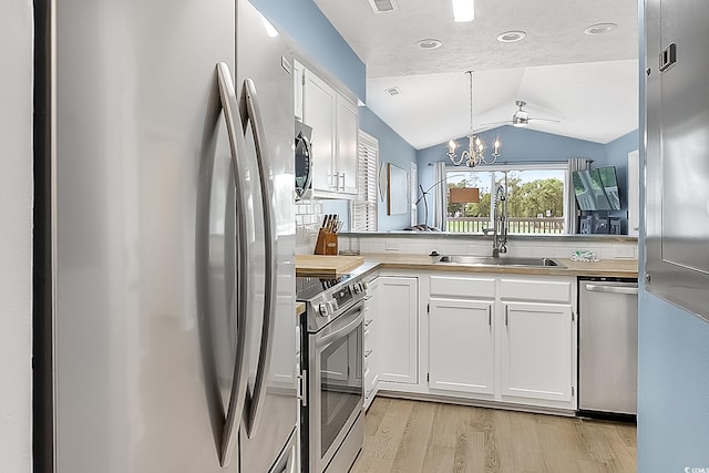 kitchen featuring stainless steel appliances, light hardwood / wood-style floors, sink, and white cabinetry