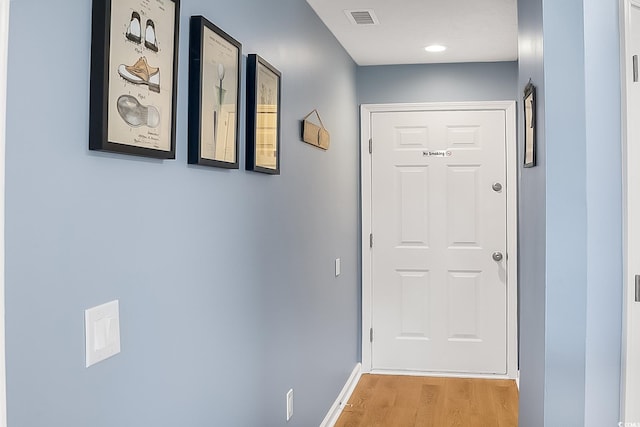 corridor with light hardwood / wood-style floors