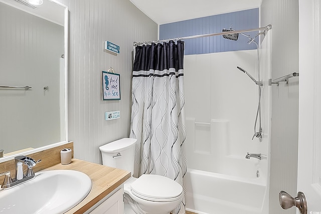 full bathroom featuring vanity, shower / bath combo with shower curtain, and toilet