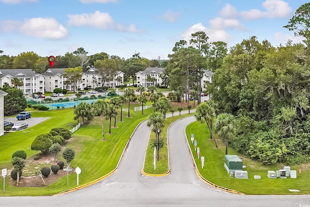 view of home's community featuring a lawn