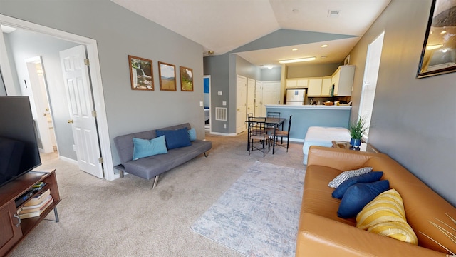 carpeted living room featuring lofted ceiling