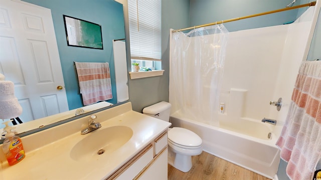 full bathroom featuring toilet, vanity, shower / tub combo, and hardwood / wood-style flooring