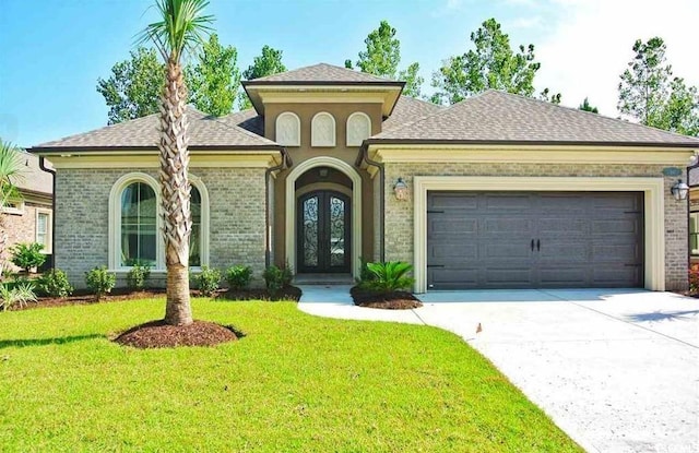 mediterranean / spanish-style home featuring a front lawn and a garage