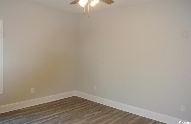 spare room featuring ceiling fan and dark hardwood / wood-style floors