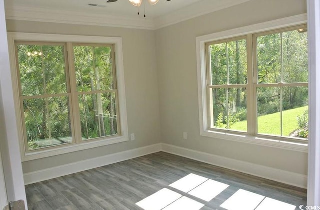 unfurnished room with ornamental molding, ceiling fan, and dark wood-type flooring