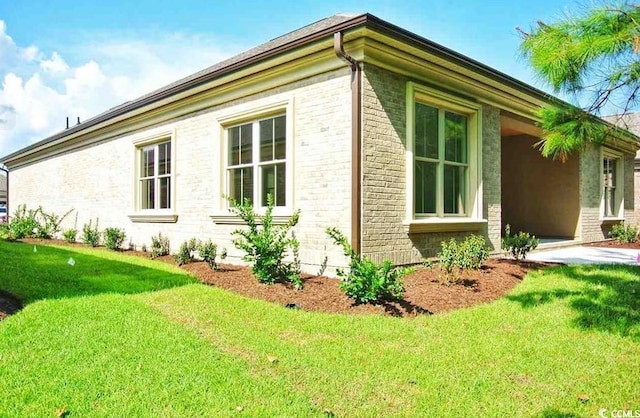 view of home's exterior with a lawn