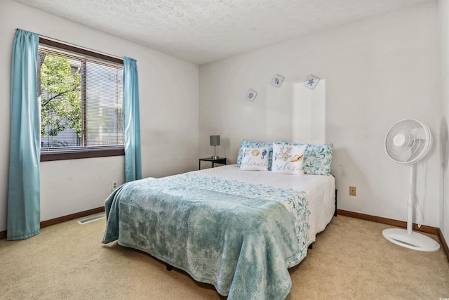 carpeted bedroom featuring a textured ceiling