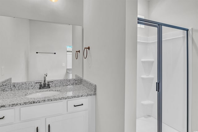 bathroom featuring vanity and an enclosed shower