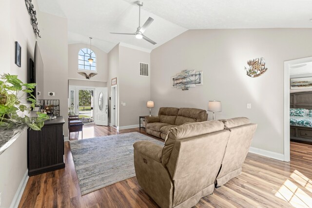 living room with lofted ceiling, wood-type flooring, and ceiling fan