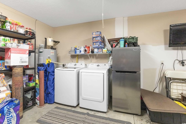 laundry area with electric water heater and washing machine and clothes dryer