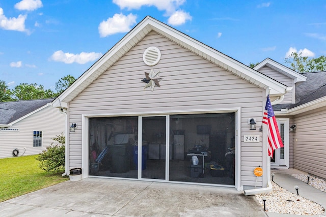 back of property featuring a garage