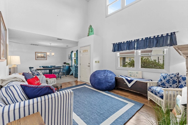 living room featuring a healthy amount of sunlight, a high ceiling, and hardwood / wood-style flooring