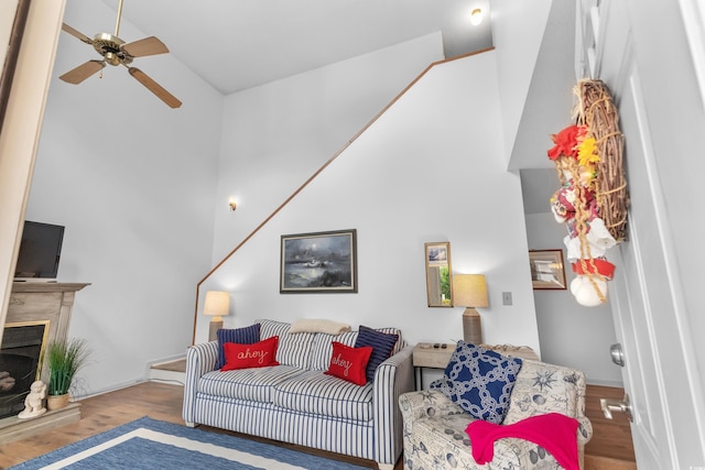 living room with hardwood / wood-style flooring, vaulted ceiling, and ceiling fan