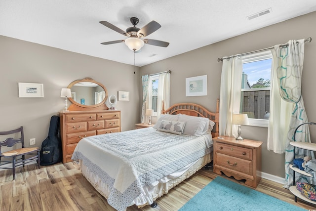 bedroom with ceiling fan and light hardwood / wood-style floors