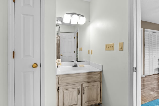 bathroom featuring vanity, a textured ceiling, and hardwood / wood-style flooring