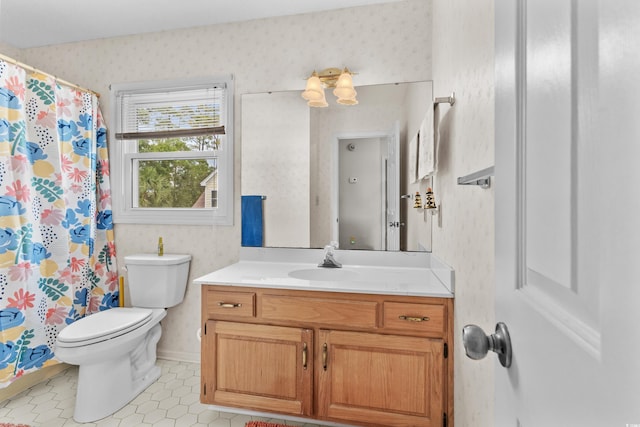 bathroom featuring tile patterned floors, vanity, and toilet