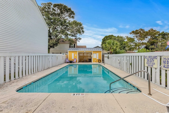 view of swimming pool with an outdoor structure