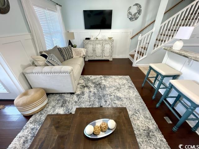 living room featuring dark wood-type flooring