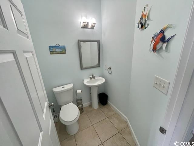 bathroom featuring tile patterned flooring, toilet, and sink