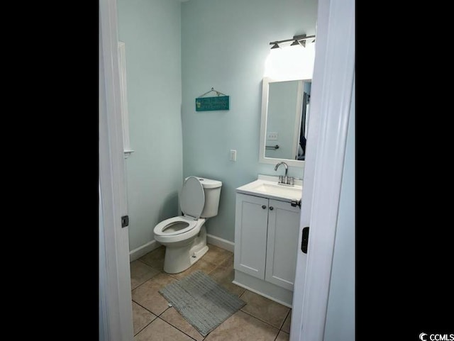 bathroom featuring tile patterned floors, vanity, and toilet