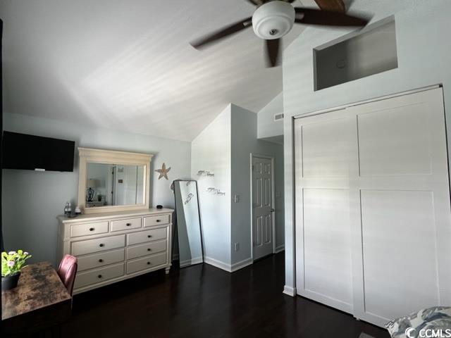 bedroom featuring a closet, lofted ceiling, ceiling fan, and dark hardwood / wood-style floors