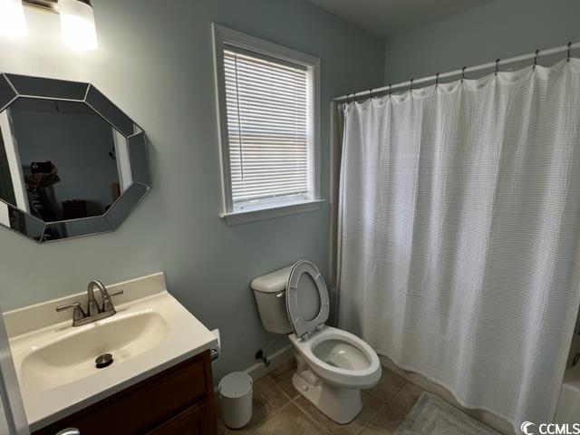 bathroom featuring vanity, tile patterned flooring, and toilet