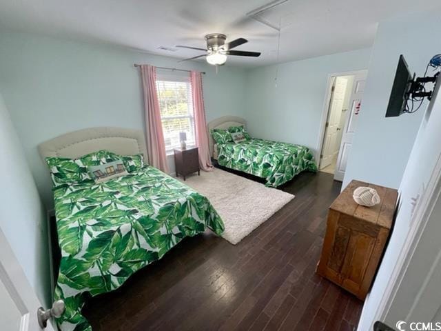 bedroom with dark hardwood / wood-style floors and ceiling fan