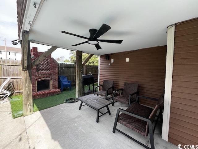 view of patio / terrace featuring ceiling fan and an outdoor brick fireplace