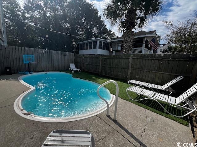 view of swimming pool featuring a patio area