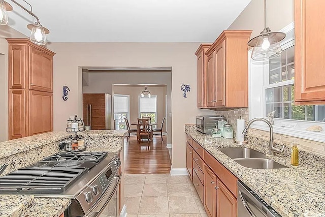 3815 Ed Smith Ave, Myrtle Beach, SC 29588 - kitchen with stainless steel appliances, a wealth of natural light, light stone counters, and a sink