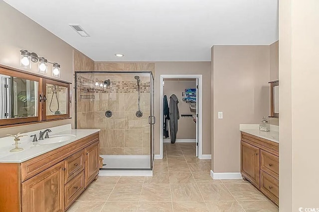 bathroom featuring vanity and a shower with door