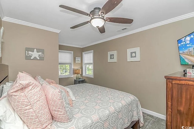 carpeted bedroom featuring ceiling fan and crown molding