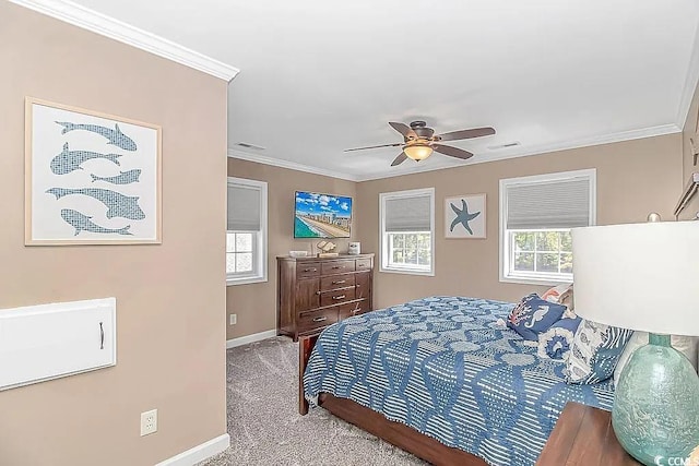 carpeted bedroom with ornamental molding and ceiling fan