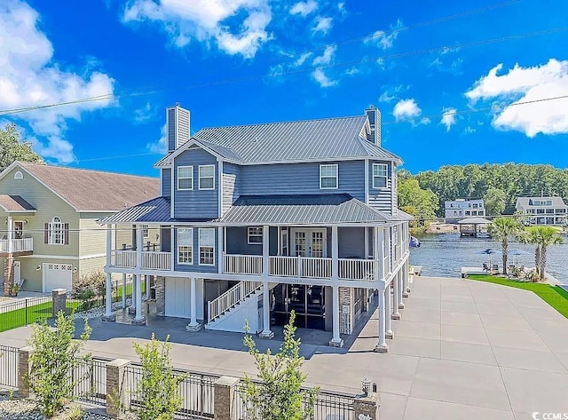 3815 Ed Smith Ave, Myrtle Beach, SC 29588 - rear view of property with metal roof, a patio, stairs, and a chimney