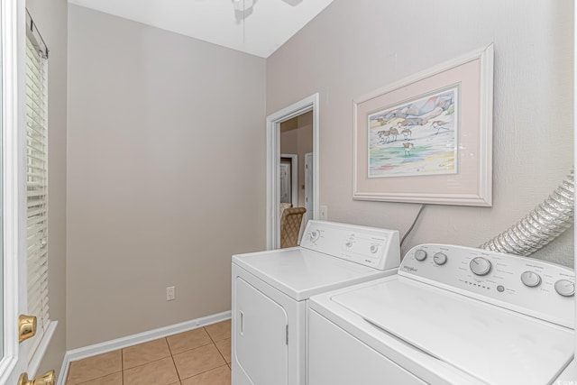 laundry room with ceiling fan, light tile patterned flooring, and washer and dryer