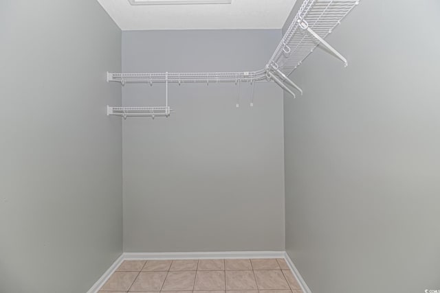 spacious closet with light tile patterned floors