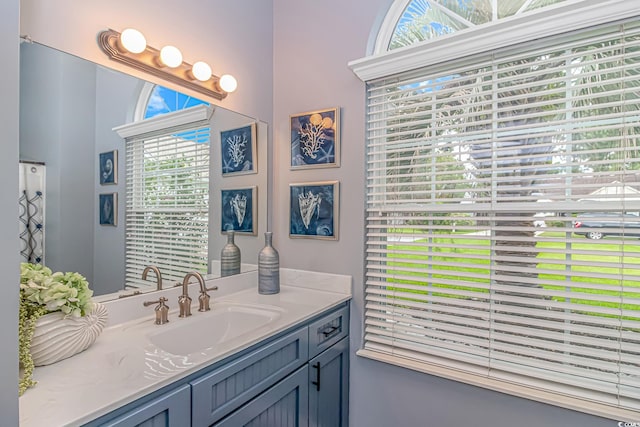 bathroom featuring a wealth of natural light and vanity