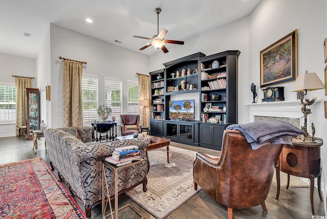 living room with a healthy amount of sunlight, dark hardwood / wood-style floors, and ceiling fan