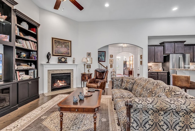 living room featuring wood-type flooring and ceiling fan