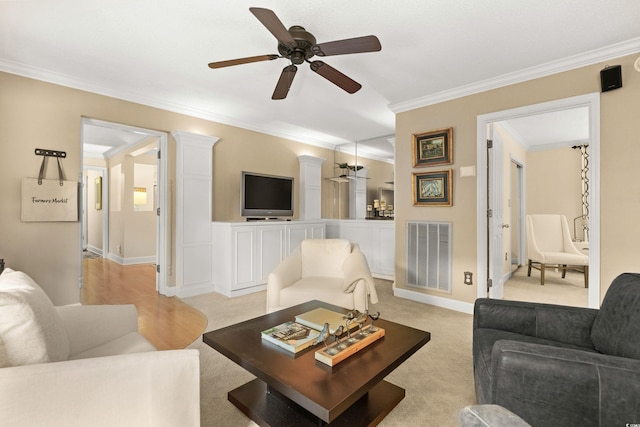 carpeted living room featuring crown molding and ceiling fan