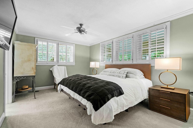 carpeted bedroom featuring a textured ceiling, ceiling fan, and crown molding